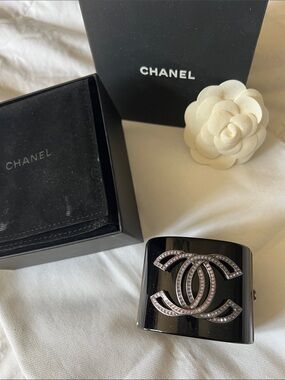 Chanel cuff shows pink diamonds in the Chanel logo. jewelry case/box included